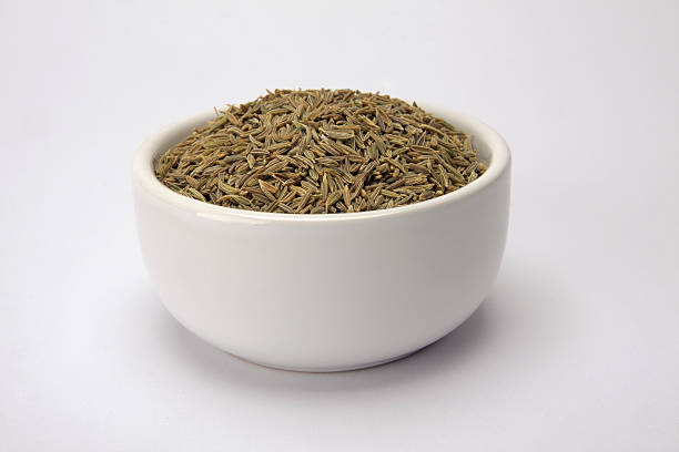 White bowl with cumin seeds stock photo