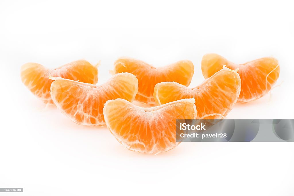 Slices of a tangerine Slices of a ripe tangerine are fancifully placed on a white background Beauty In Nature Stock Photo