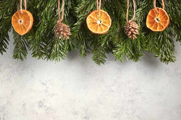 istock Zero waste and eco friendly christmas concept. Christmas tree branches with natural decorations on a gray wall. Horizontal banner with copy space 1448044643