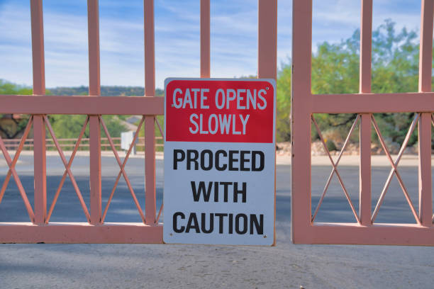 istock Gate opens slowly Proceed with caution signage on a metal gate at Tucson, Arizona 1448046131