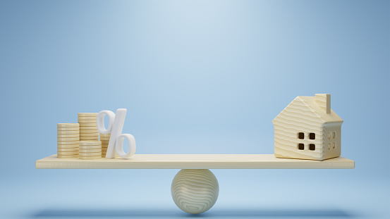 3d rendering. wooden coins stack and wooden home on weigh scale on blue background. investment property concept.