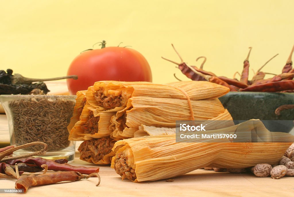 Mexican Food Tamales With Red Peppers and Pinto Beans on Yellow Background Tamale - Food Stock Photo