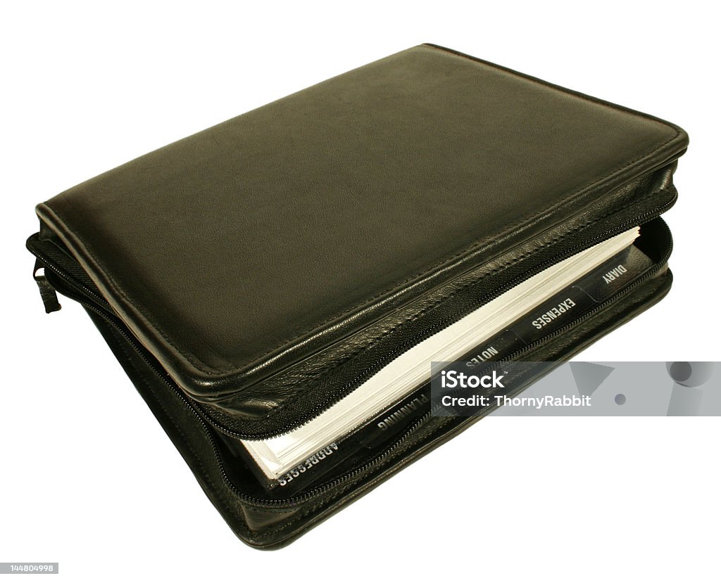 Leather Filofax Filofax isolated on white background. Focus on front area. Organisation tabs visible. Address Book Stock Photo
