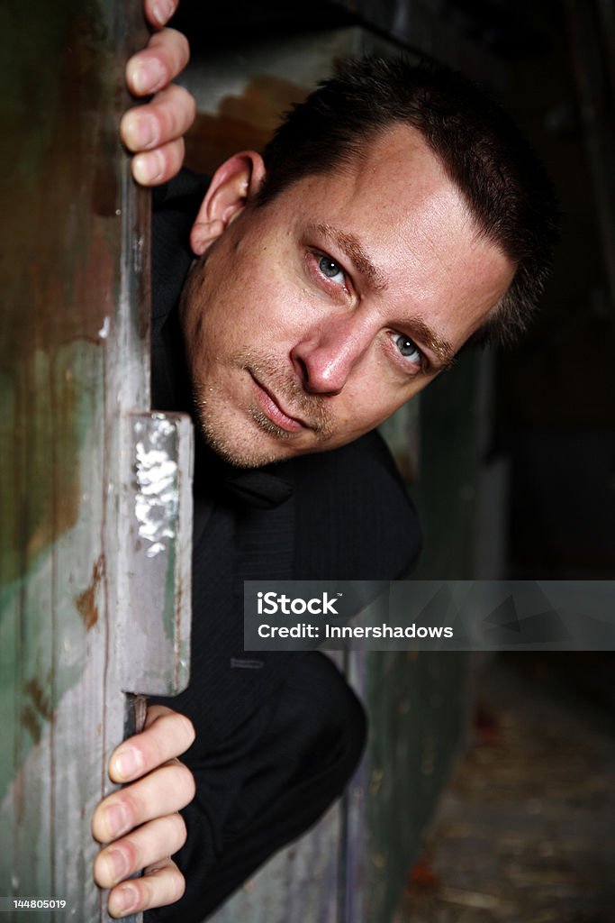 Hide and seek Young man hiding in cupboard Hiding Stock Photo