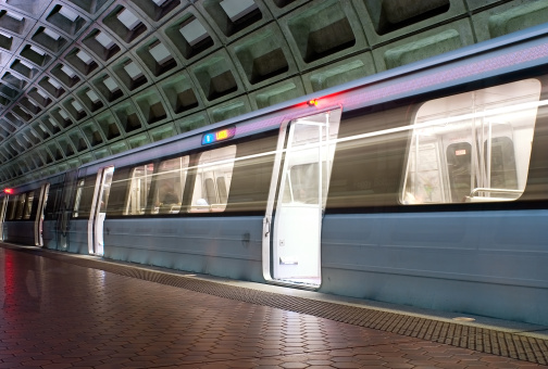 Photograph of a Washington DC metro subway as it comes to a stop at the Foggy Bottom station.