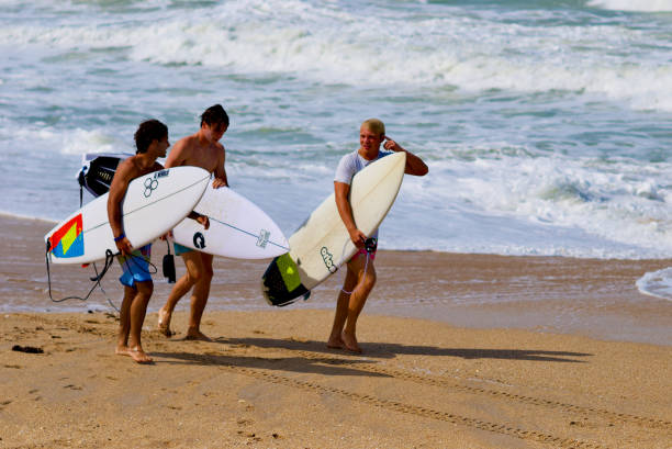 Surfers Walk Along the Beach, New Smyrna Beach, Florida (USA) stock photo