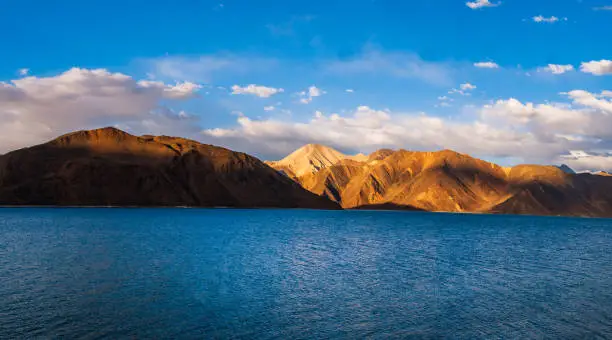 Pangong Lake worlds highest saltwater lake dyed in blue stand in stark contrast to the arid mountains surrounding it. Famous lakes in Leh Ladakh.