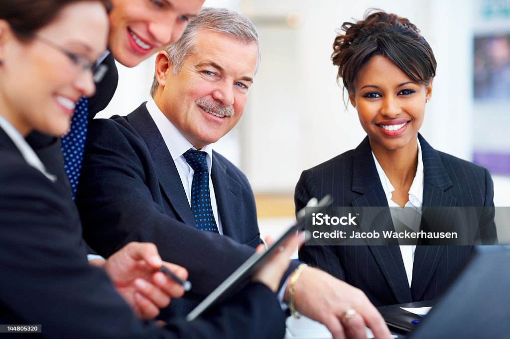 Four business people in a meeting Four business people in a meeting. Occupation Stock Photo