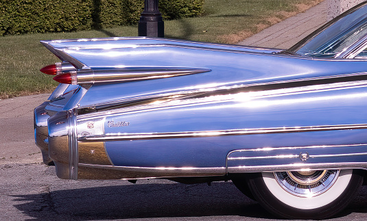 Windsor, Ontario, Canada - August 12, 2022:  Classic cars driving around downtown Windsor during  a classic car cruise community event.  This is a closeup of a classic vintage Cadillac.