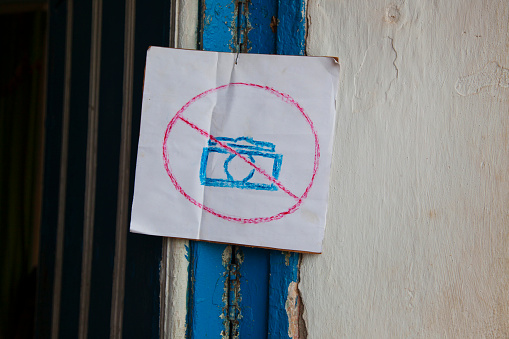 A scrawled of a camera with a line through it, signifying \