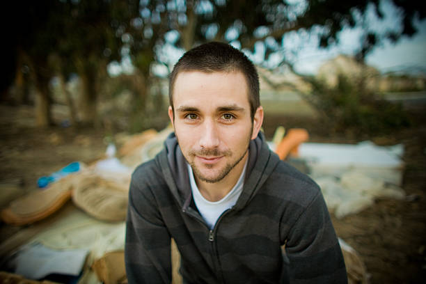 young man near trash stock photo