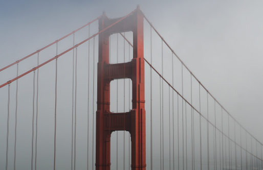 Golden Gate Bridge shrouded in dense fog.