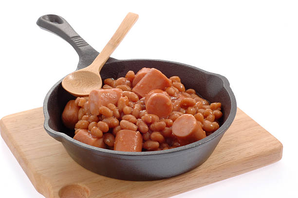 Beans and wieners in a cast iron skillet.