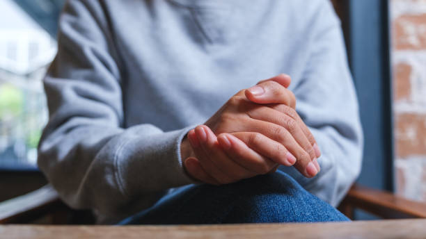 istock Closeup image of a woman with holding hands while thinking, waiting, praying or making decision 1448060193