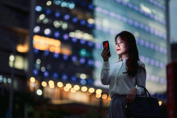 istock Young businesswoman using smartphone in financial district, 1448061310