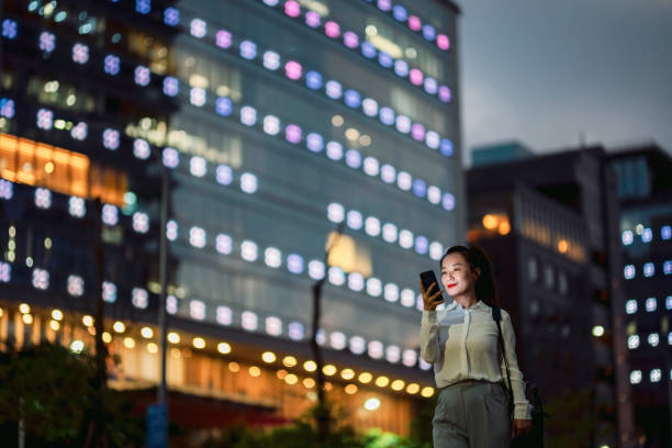 istock Young businesswoman using smartphone in financial district, 1448061311