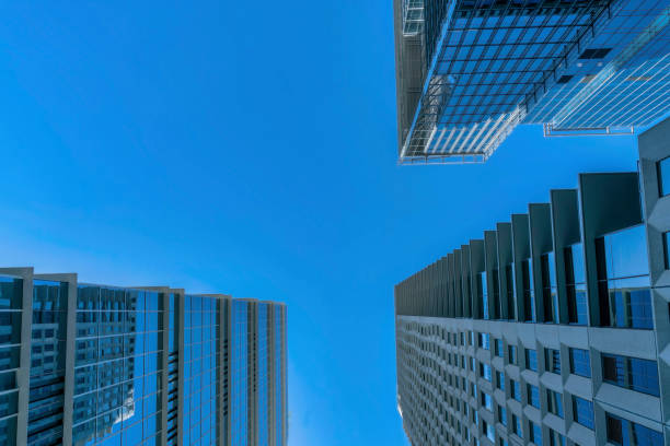 istock Looking up at the cloudless blue sky with residential buildings underneath 1448065538