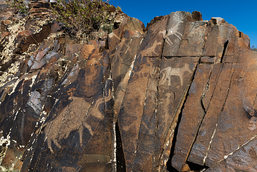 Hand-drawn rocks (Petroglyphs) in Cholpon-Ata city, Kyrgyzstan.\nNorth of the centre is an extensive field of glacial boulders, many with pictures scratched or picked into their surfaces. Some of these petroglyphs date from the Bronze Age (about 1500 BC), but most are Saka-Usun (8th century BC to 1st century AD), Most are of long-horned ibex.