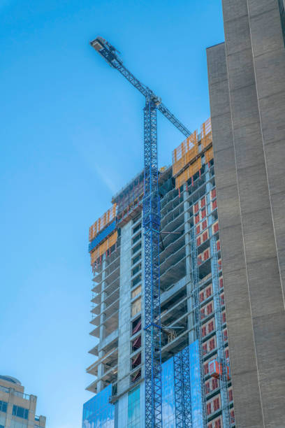 istock Construction crane in front of an unfinished building in downtown Austin Texas 1448066431