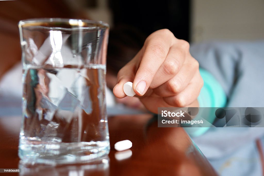 Woman with a flu taking pill  Woman with a flu taking pill                               Sleeping Stock Photo