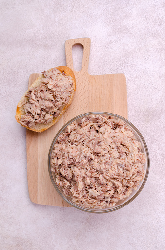 Traditional fish pate in a glass dish on a light background. Top view.