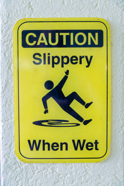 istock Caution Slippery When Wet sign against white concrete wall in Destin Florida 1448069177