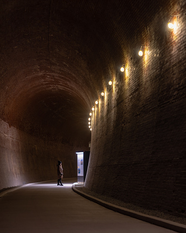 Niagara Falls, Canada - December 9, 2022 : A person taking the tour of The Tunnel at the Niagara Parks Power Station