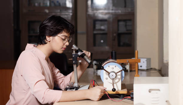 istock Indian girl student working or experimenting in science lab. 1448069409