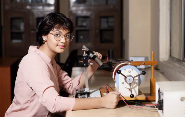 indian girl student working or experimenting in science lab. - physics classroom teaching professor imagens e fotografias de stock