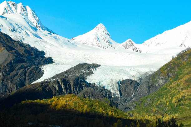 Worthington Glacier and Chugach Mountains in Fall The Worthington Glacier is located near Valdez, Alaska. This glacier  is able to be reached by a car. Traveling along the Richardson Highway, this glacier is a popular stopping ground for many tourists. On this day it was a beautiful sight with the Chugach Mountains rising in the distance. The fall colors shine against the bright snow. Worthington stock pictures, royalty-free photos & images