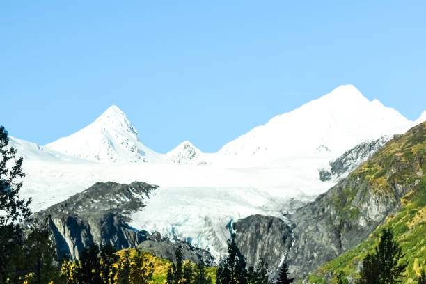 Worthington Glacier and Chugach Mountains in Fall The Worthington Glacier is located near Valdez, Alaska. This glacier  is able to be reached by a car. Traveling along the Richardson Highway, this glacier is a popular stopping ground for many tourists. On this day it was a beautiful sight with the Chugach Mountains rising in the distance. The fall colors shine against the bright snow. Worthington stock pictures, royalty-free photos & images