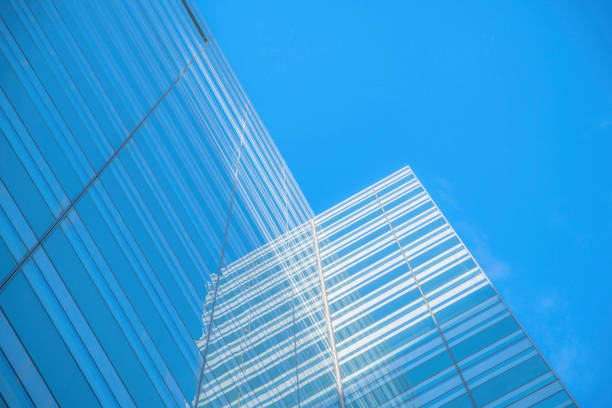 Austin, Texas- Low angle view of a building with reflective glass exterior. Glass building exterior against the blue sky background.