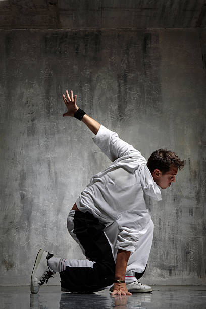istock A young man dancing alone next to a gray concrete wall 144807377