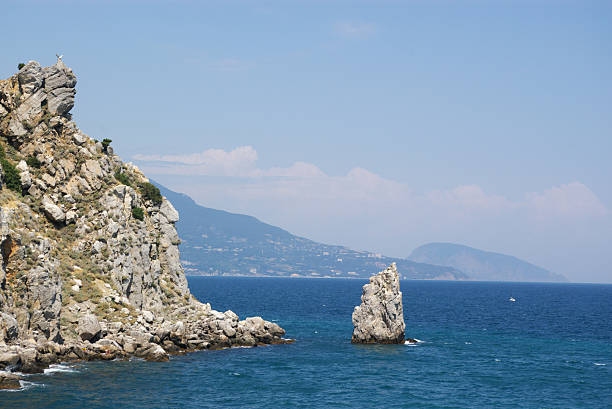 istock rock and cliff in blue sea 144807398