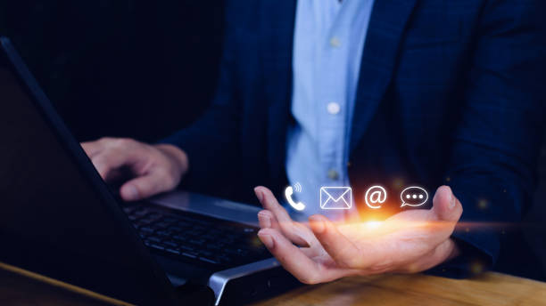 istock Contact us or Customer support hotline people connect. Businessman using showing and touching on virtual screen contact icons ( call phone, email, address, live chat, ) 1448074469