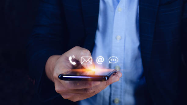 istock Customer support hotline Contact us people connection, Businessman using pointing touching Smart Phone with email, call phone, address, Chat message icons, Communication concept 1448074475