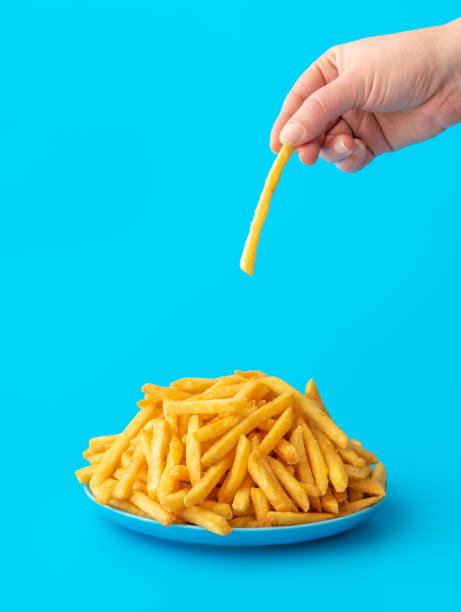 French fries plate isolated on a blue background. stock photo