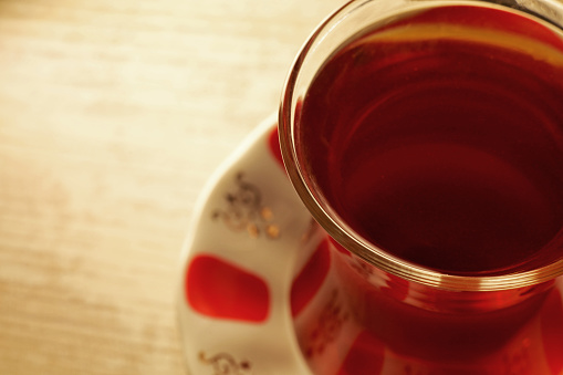 Glass of Turkish tea on wooden table