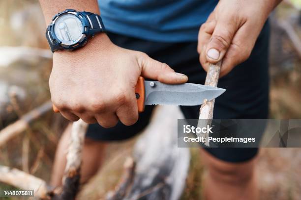 Hands Knife And Cutting With A Hiking Man Carving A Stick Outdoor In Nature While Camping For Adventure Wood Weapon And Tool With A Male Camper Slicing A Twig In The Mountains For Survival Stock Photo - Download Image Now