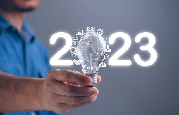 istock Business strategy, success, 2023 goals, ideas, target, action plan, growth, market, development, investment, innovation technology concept. Businessman hand holding 2023 light bulb sparkling effect 1448078730