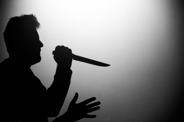istock shadow of a man with a knife and kitchen accessories 1448078893