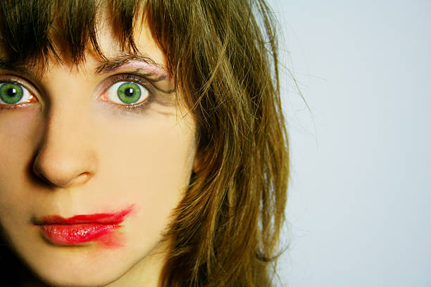 Close up of woman with smudged lipstick staring stock photo