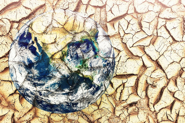 istock The Earth etched on a lake bed left dry and cracked by climate change, global warming and drought 1448081961