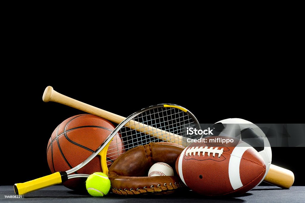 Sports equipment with rackets and balls Misc. Sports equipment on a black background with copy space above Sport Stock Photo