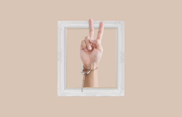 istock Hand showing peace hand sign, and picture frame 1448086180