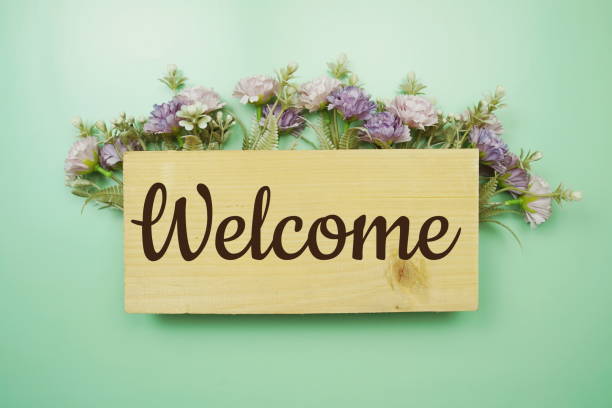 istock Welcome Sign with flowers frame decorate on green background 1448087275