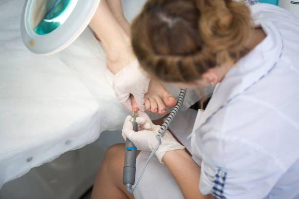istock Professional pedicure master making pedicure in salon 1448089456