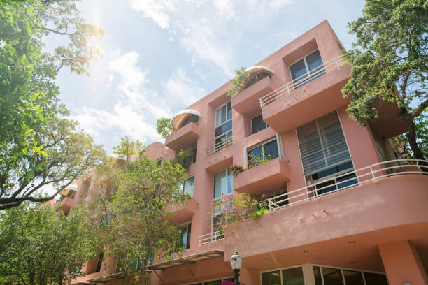 istock Building with painted peach wall and balconies facing the trees at the front- Miami, FL 1448089616