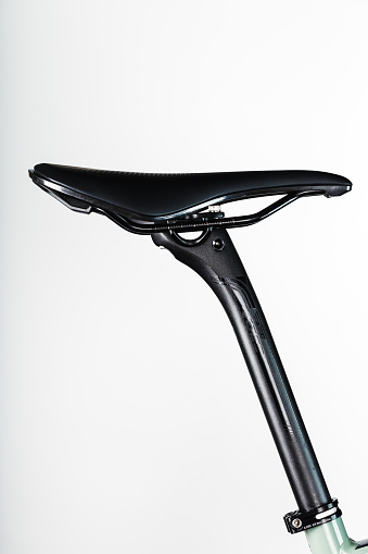 Bicycle saddle on a light background accessories for bike repair and tuning