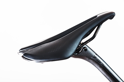 Bicycle saddle on a light background accessories for bike repair and tuning